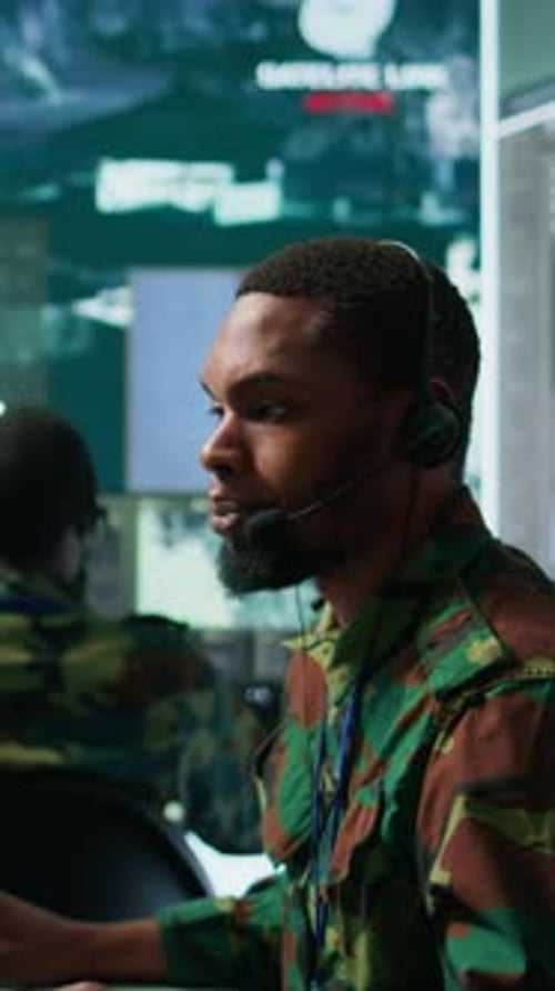 Serious Men Monitor Data Feeds in Dark Room