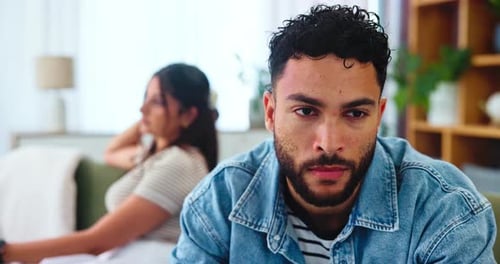 Couple, man and frustrated in home after fight, disagreement and toxic relationship in lounge