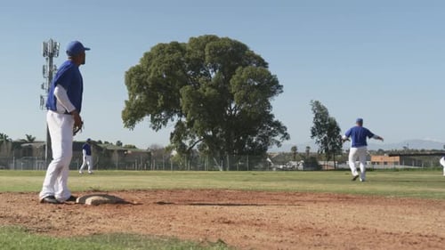 Playing baseball, athletes on field competing in game, wearing uniforms and helmets