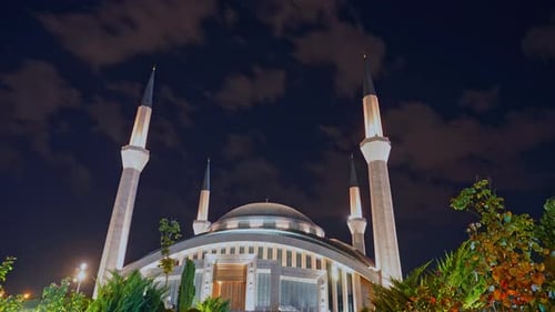 Night Timelapse of Illuminated Mosque with Moving Clouds
