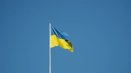 Ukrainian Flag Waving Against a Clear Blue Sky
