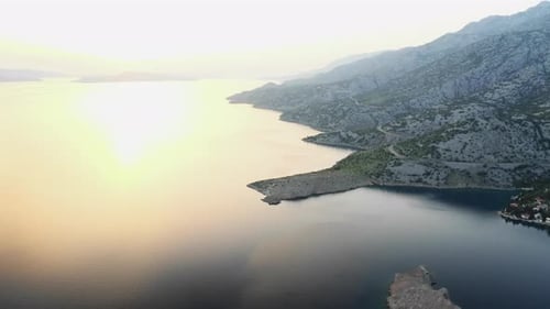 Tranquil Coastline Featuring Calm Waters at Sunset Aerial View