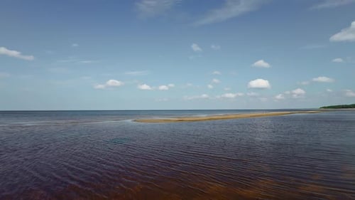 Aerial view of a narrow beach between water