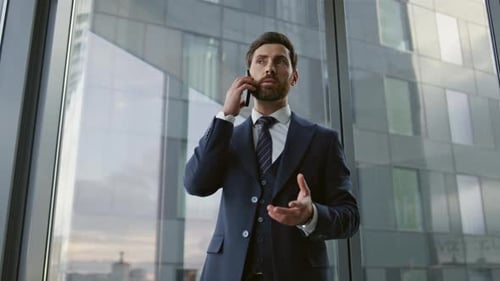 Confident Businessman Talking Phone Near Office Window Closeup. Serious Bearded Boss Having Smart...
