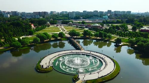 Amazing fountain in lake with pedestrian bridges at historical palace.