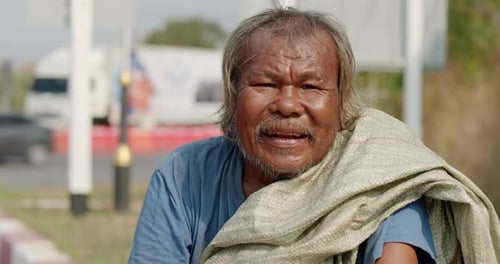 Smiling Senior Man Sitting Outdoors
