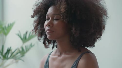 Close-up of a young woman face with eyes closed while yoga.