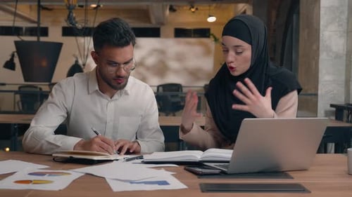 Coworkers Discussing Project at Desk