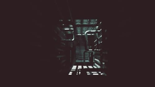 Exploring the Dark Concrete Interior of an Industrial Building at Night