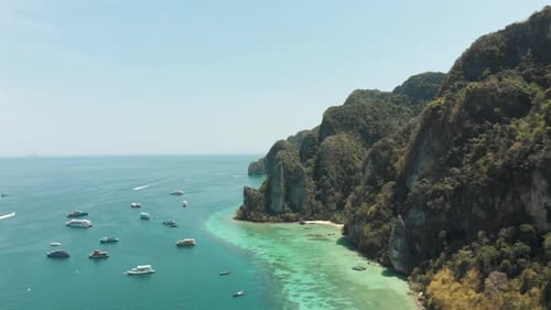 Towering Limestone stalled by shoreline winding around Ko Phi Phi Don Island Paradise, Thailand - Ae