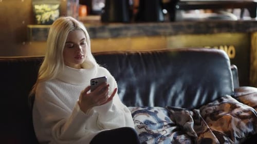 Female Friends Meeting Girls Hug While Sitting on Sofa in Cafe