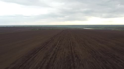 Blue tractor OA working on the field in Ukraine