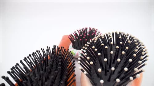 Used hair brush comb close up on white background isolated 4K