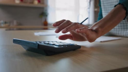 Close Up Female Hands Calculating Numbers on Calculator Writing Notes in Notebook Counting Domestic