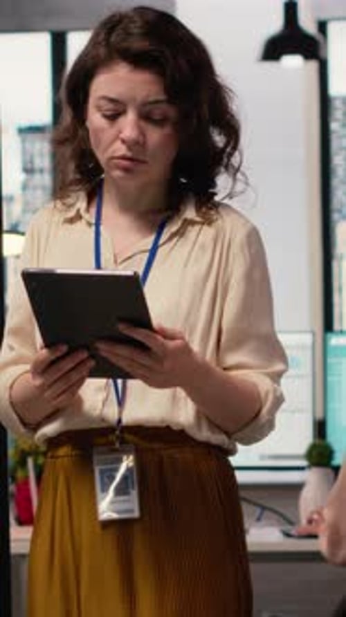 Vertical Video Female Administrator Reviewing the Performance Numbers of Her Team