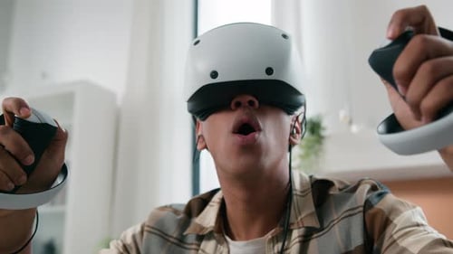 Man Wearing VR Headset with Controllers