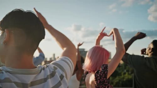 Close Up of Diverse Stylish Friends Dancing on Urban Rooftop