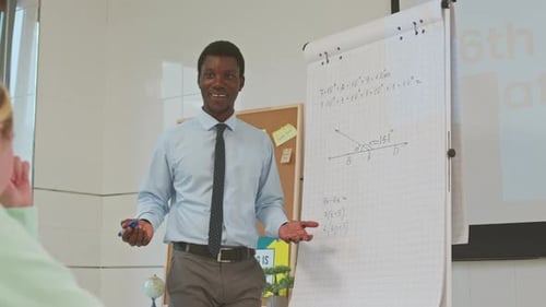 Teacher Giving Math Lesson in Classroom