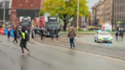 People Running in City Marathon on Wet Day