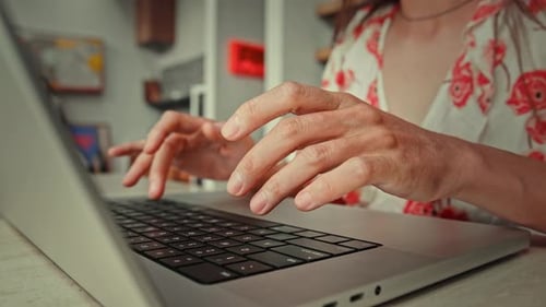 Hands of Woman Typing on Keyboard of Laptop Computer and Working in Home Office