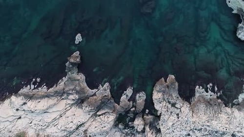Breathtaking top aerial view of clear blue ocean and calm sea at rocky cliff
