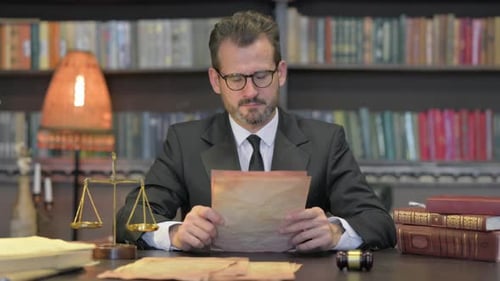 Middle Aged Lawyer Reading Court Orders in Office