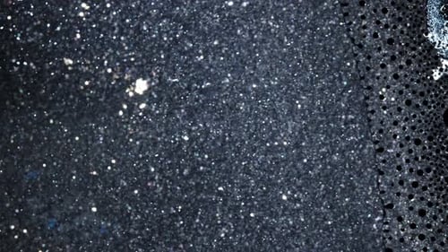 Shot of Ink Mixing with Intricate Dark Textures and Speckles