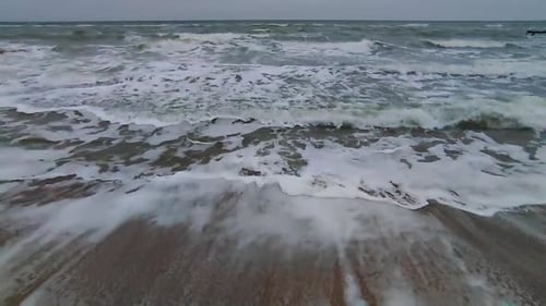 Stormy Sea at Dusk View of the Sea During Storm on Sandy Beach in the Evening