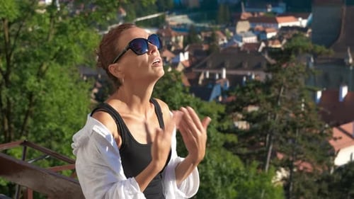 Woman Enjoying City View on a Sunny Day