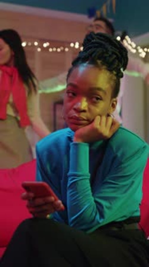 Bored Woman at Party with Cellphone