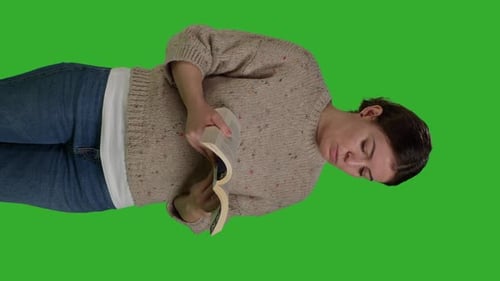Vertical Video Front View of Young Person with Action Book Reading in Studio