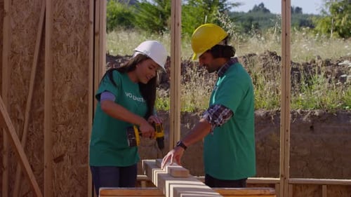 Volunteers Building a House Together on a Sunny Day