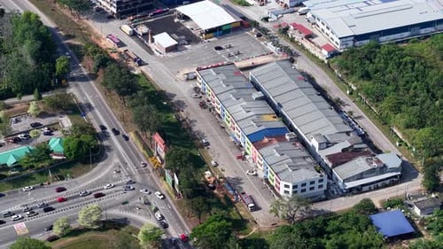 Aerial view of industrial buildings near a busy road