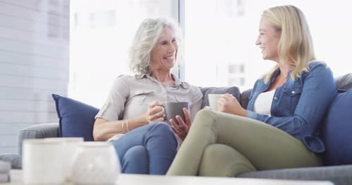 Senior Woman and Young Woman Talking on Couch