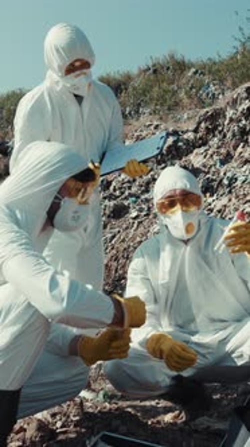 Researchers in Protective Suits Examining Contaminated Area