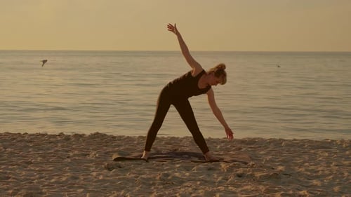 Sports Yoga Training Workout Adult Woman Doing Exercises on Fitness Mat at Sunset Beach