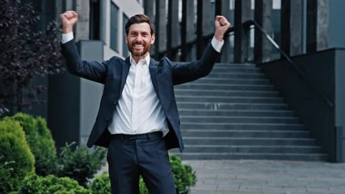 Bearded Man in Suit Celebrates Success Outdoors