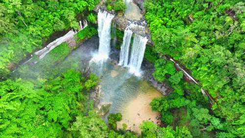 A waterfall in a beautiful tropical forest. Drone view.