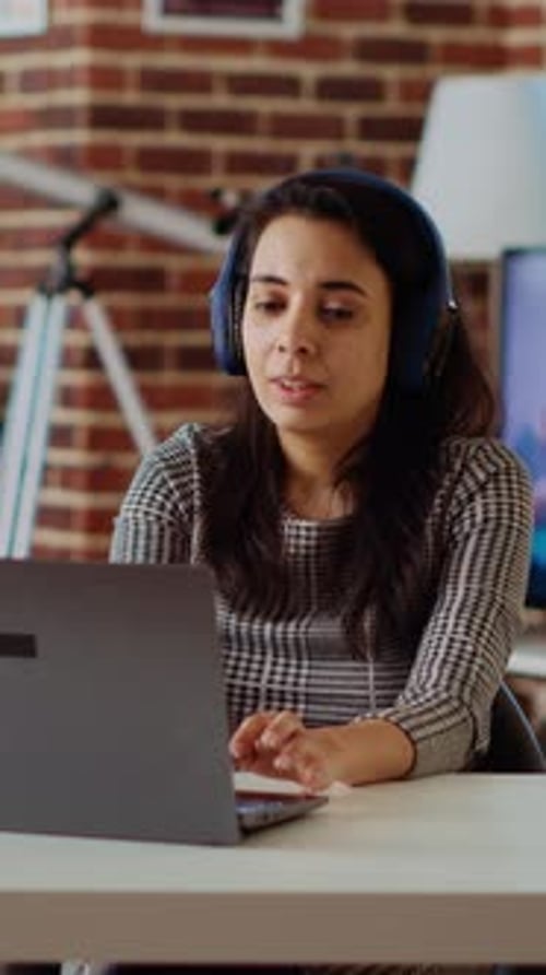 Vertical Video Woman Wearing Headphones Answering HR Interview Questions During Videoconference