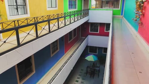 Colorful Multistory Hostel Building Open Corridor With Vibrant Red Blue Yellow And Green Colored Wal