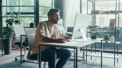 Focused Professional Finished Working at Their Computer Device in a Modern Openspace Office