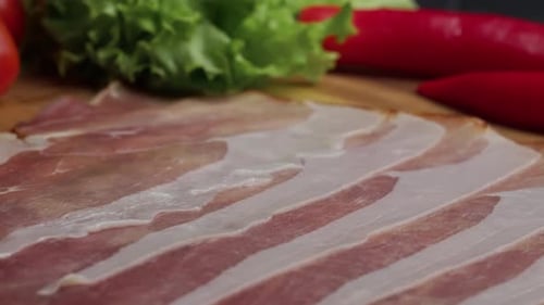 Tranches de bacon fumé cru sur planche de bois Jamon Serrano espagnol traditionnel Close Up ProRes