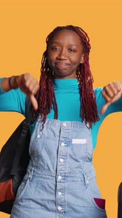 Young Woman Expresses Disapproval With Thumbs Down