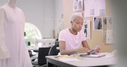 Fashion designer selecting fabrics for designs