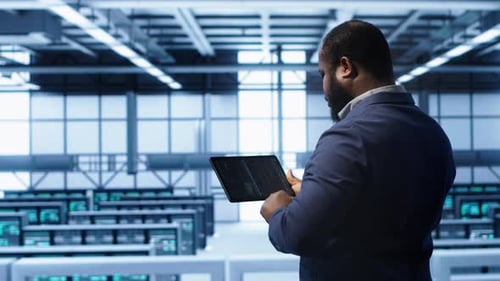 IT Expert in Server Hub Facility Looking for Network Bugs with Tablet