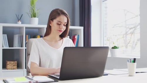 Young Woman Works at Home Office Using Computer Workplace of Female Entrepreneur Freelancer or