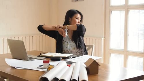 An architect or engineer woman stretch and relax from fatigue after work all day. Architectural conc