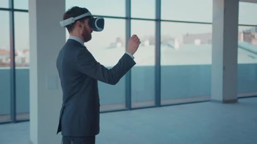 Man using VR headset in empty office space