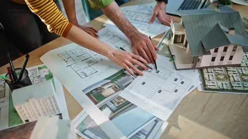 Architectural Designers Reviewing Building Plan on Office Closeup Hands Mark Up