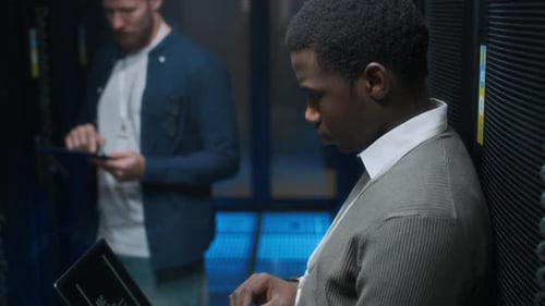 System Engineers Working With Servers in Data Center